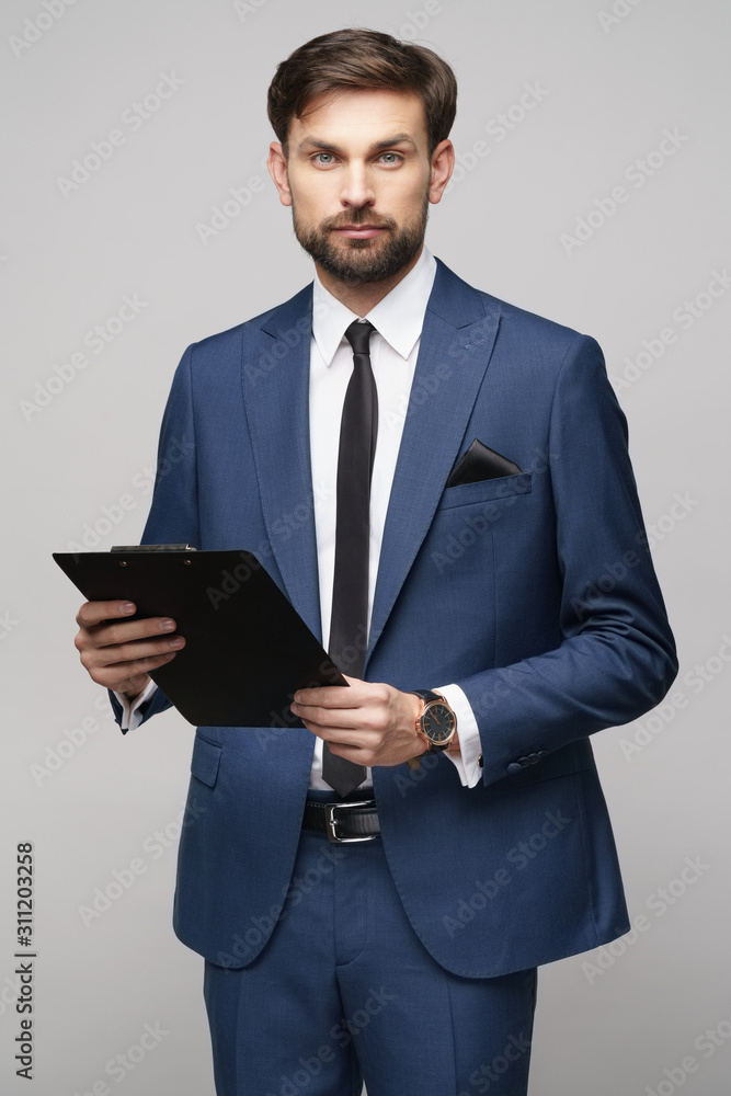 Portrait of a handsome young business man holding folder Portrait of a handsome young business man holding folder