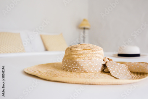 hat are on the white bed in the hotel.