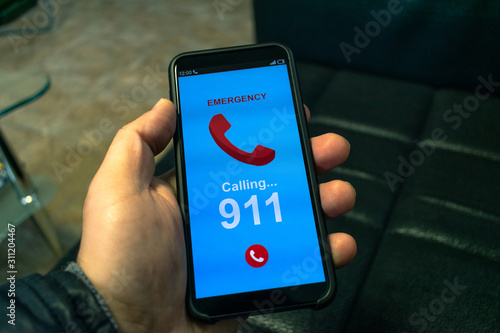 A man is calling 911. A man's hand with a smartphone. Emergency call concept