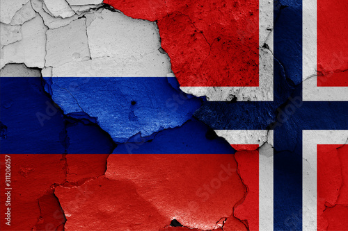 flags of Russia and Norway painted on cracked wall