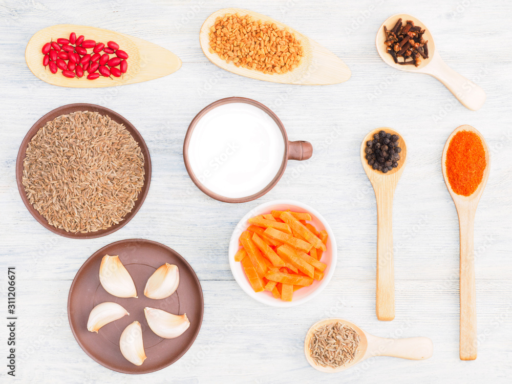 Spices, vegetables and herbs for cooking: masala, cumin (jeera), chili, masala, bay leaves, garlic, carrot, fenugreek, cloves, yogurt, turmeric. Healthy eating concept Spices, vegetables and herbs for cooking: masala, cumin (jeera), chili, masala, bay leaves, garlic, carrot, fenugreek, cloves, yogurt, turmeric. Healthy eating concept