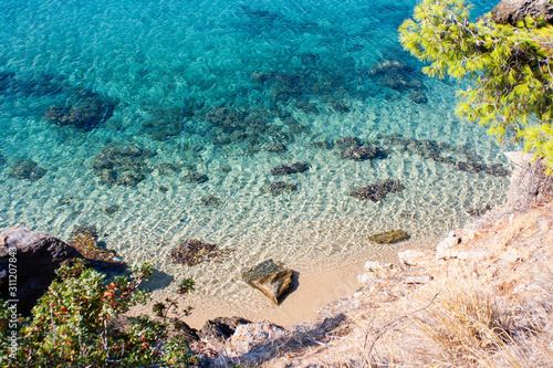 Turquoise water and beach shot from above on a secluded Mediterranean beach