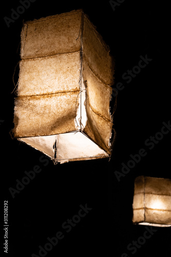 Japanese style ceiling lamps with fabric panels glowing in the dark