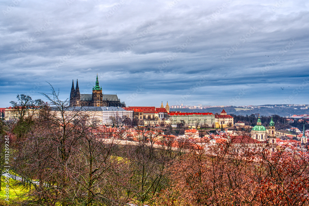 View of the little side in historical part of Prague with cathedral and castle over orchard