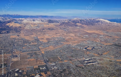 Daybreak Lake and Community and Oquirrh Mountains aerial, Copper Mine, Wasatch Front Rocky Mountains from airplane during fall. South Jordan and Herriman, Utah. United States of America. USA. photo