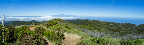 Wide Panoramic view from Garajonay peak in La Gomera. Paradise for hiking. Island of Tenerife with volcano Teide in the background. Travel postcard. Canary Islands, Spain