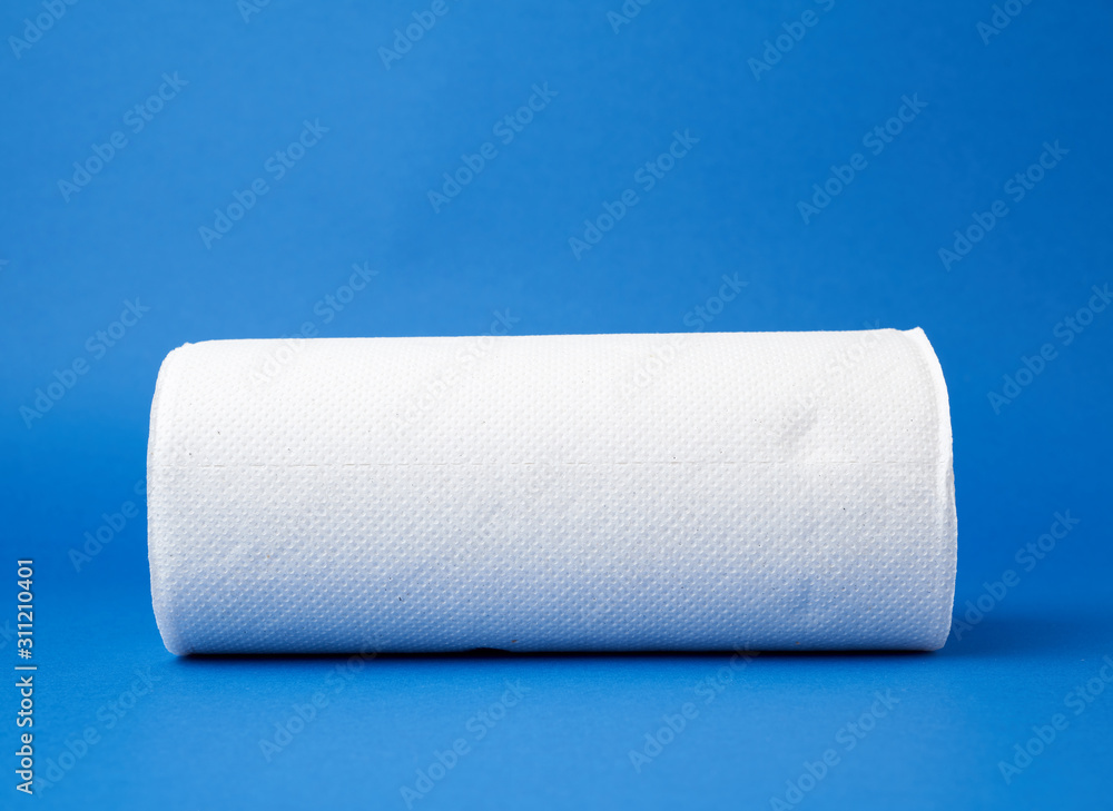 Obraz premium twisted roll of white paper towel on a blue background