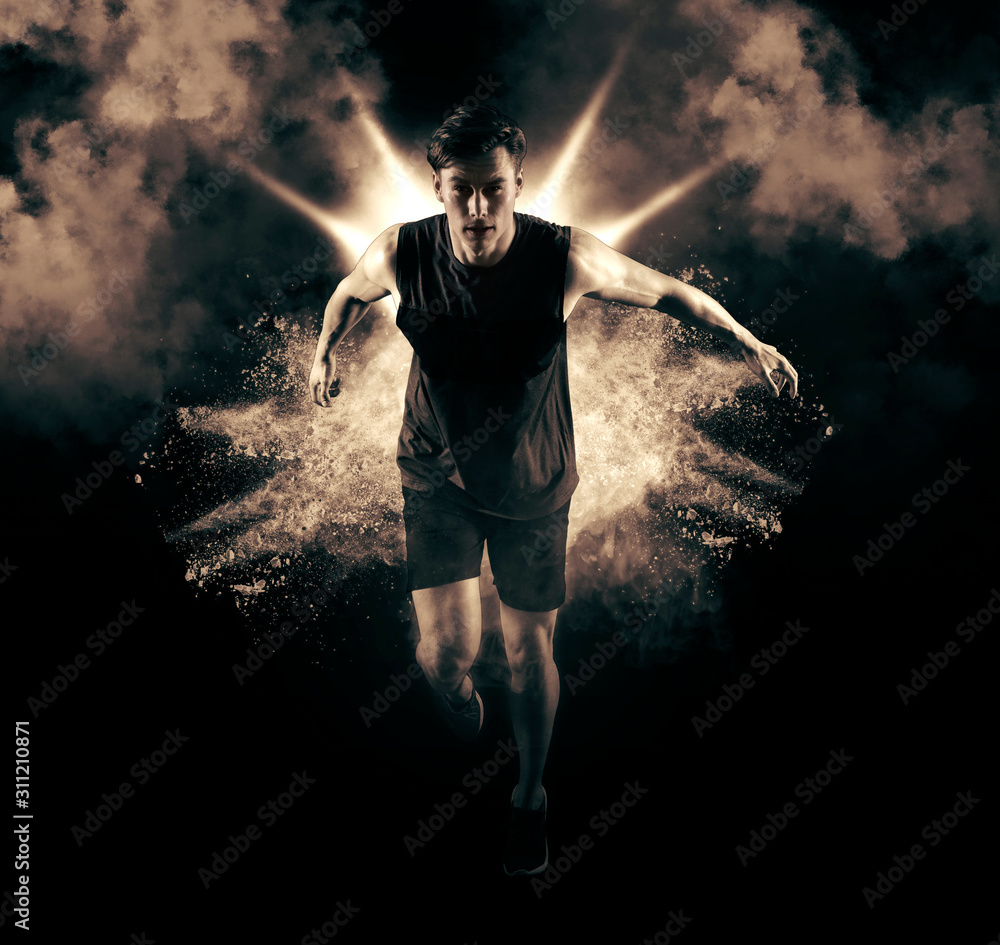 Athletic man sprinter running on smoke background