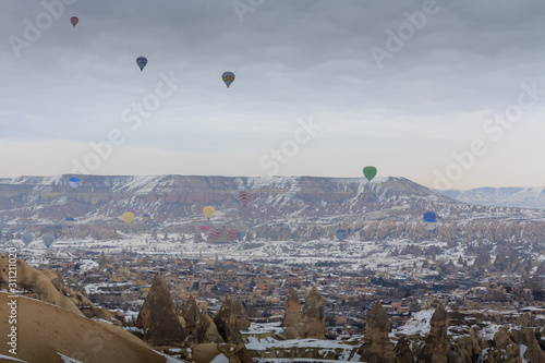 Cappadocia caves and balloons in the snow