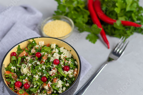 Wallpaper Mural Tabule salad in a round plate on a light gray background under concrete. Torontodigital.ca