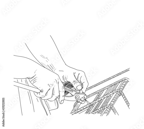 Hand draw workers hands using steel wire and pincers to secure rebar before concrete is poured over it. Selective focus on center portion of image. Construction site worker , closeup hands , form work