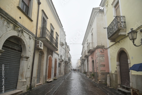 Ancient Houses and Buildings in Troia, Foggia, Italy, at Morning with Foggy Weather