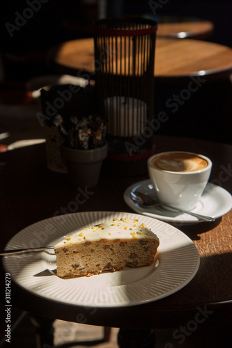cup of coffee and cake on wooden table.