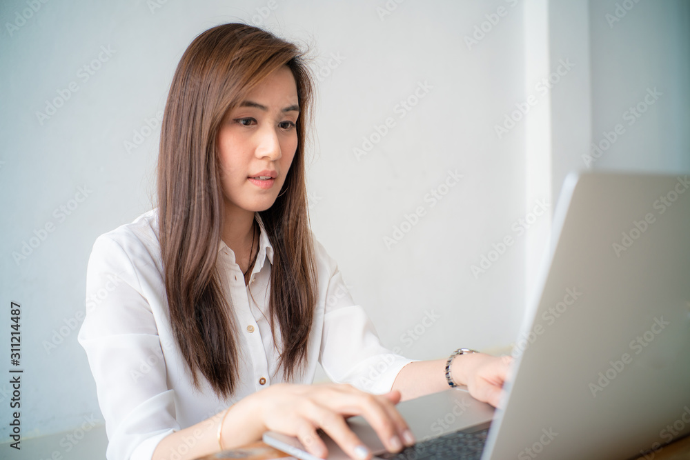 Business asian women casual wear sitting in cozy living room use internet by laptop Business asian women casual wear sitting in cozy living room use internet by laptop