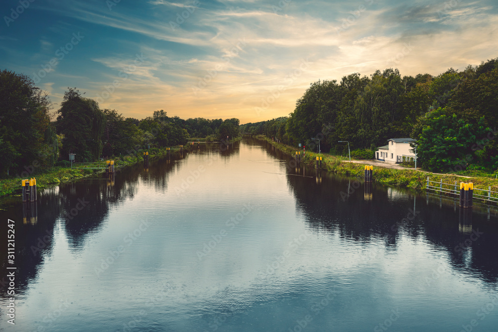 Fototapeta premium beautiful canal landscape with evening sky and smooth water