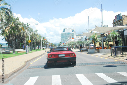 Red car driving to the coast, Tauranga, New Zealand