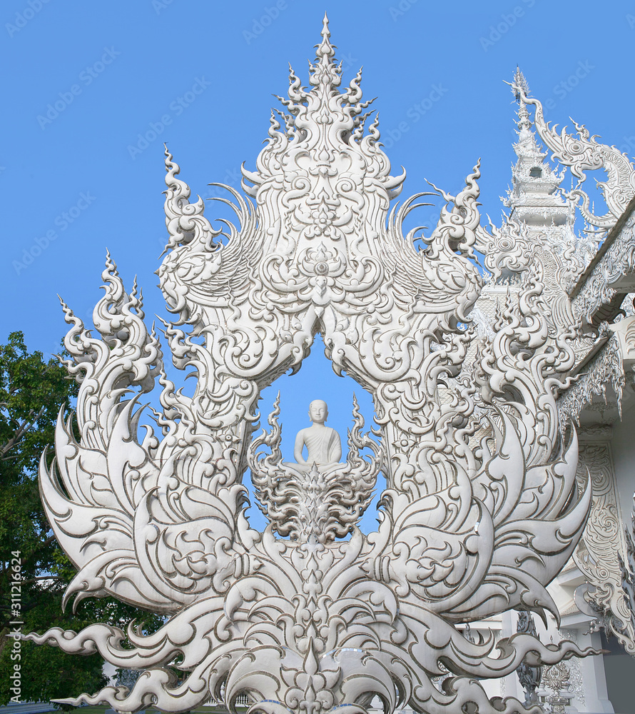 Exterior detail with White Buddha at famous Wat Rong Khun, or White Temple in Chiang Rai Province, Northern Thailand