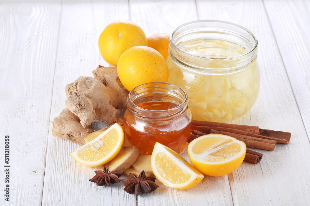 Still life with lemon, ginger and honey on a white background Still life with lemon, ginger and honey on a white background