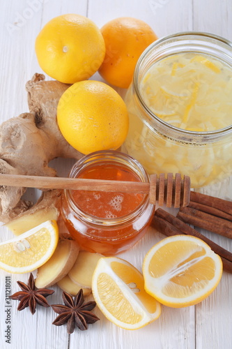 Still life with lemon, ginger and honey on a white background