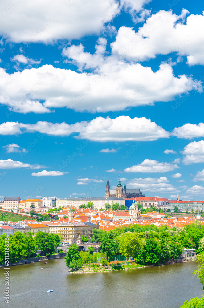 Aerial vertical view of Prague city, historical center with Prague Castle, St. Vitus Cathedral in Hradcany district, Strelecky island, Vltava river, blue sky white clouds, Bohemia, Czech Republic