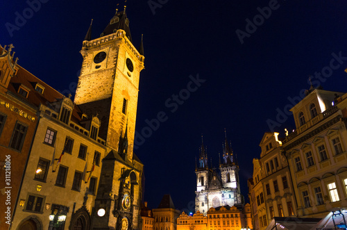 Prague Old Town Square (Stare Mesto) historical city centre. Astronomical Clock (Orloj) and Tower of City Hall building, Gothic Church of Our Lady before Tyn, night view, Bohemia, Czech Republic