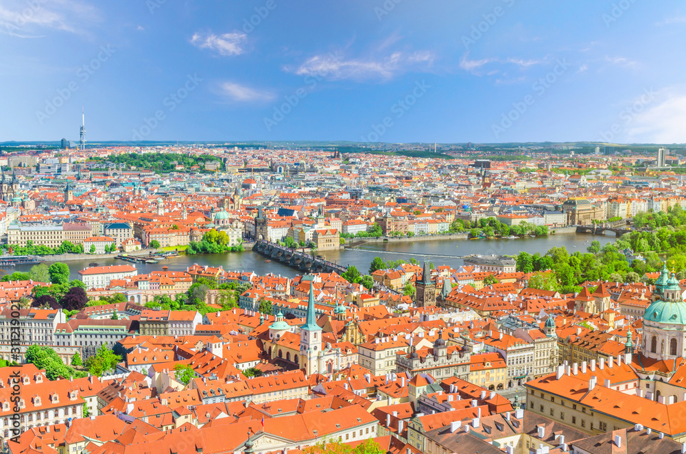 Top aerial panoramic view of Prague historical city centre with red tiled roof buildings in Mala Strana Lesser Town and Old Town, Charles Bridge Karluv Most over Vltava river, Bohemia, Czech Republic