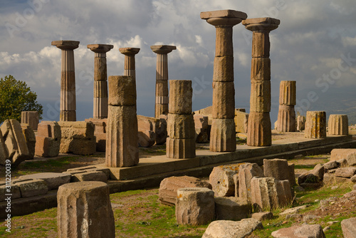 Cliff top ruins with Doric columns of the temple of Athena over the Aegean Sea coast at Assos Behramkale Turkey photo