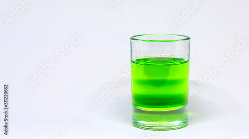Wallpaper Mural Small glass with a liquid, alcohol drink. Colored watery drink absinthe, curacao, cognac. Torontodigital.ca