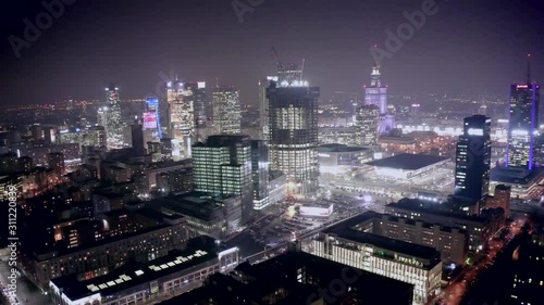 Wallpaper Mural Drone shot at night cityscape with skyscrapers and buildings on a foggy night. Warsaw-Poland. 04. December. 2019. Aerial view of the night city with traffic and skyscrapers in the fog. Torontodigital.ca