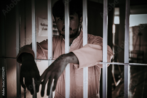 Hands of men desperate to catch the iron prison,prisoner concept,thailand people,Hope to be free.