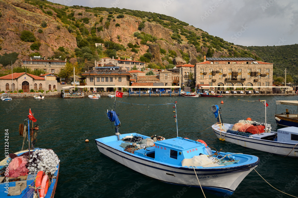 Cliffside village hamlet of Assos Iskele or Behram Turkey with boats hotels and restaurants