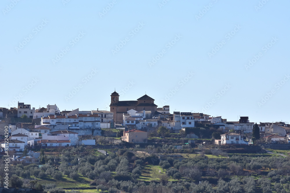 Panoramic view of the Granada town of Nívar with the silhouette of its great church