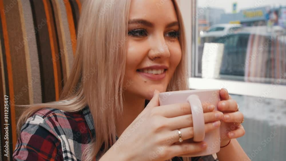 A young woman drinking coffee in cafe A young woman drinking coffee in cafe