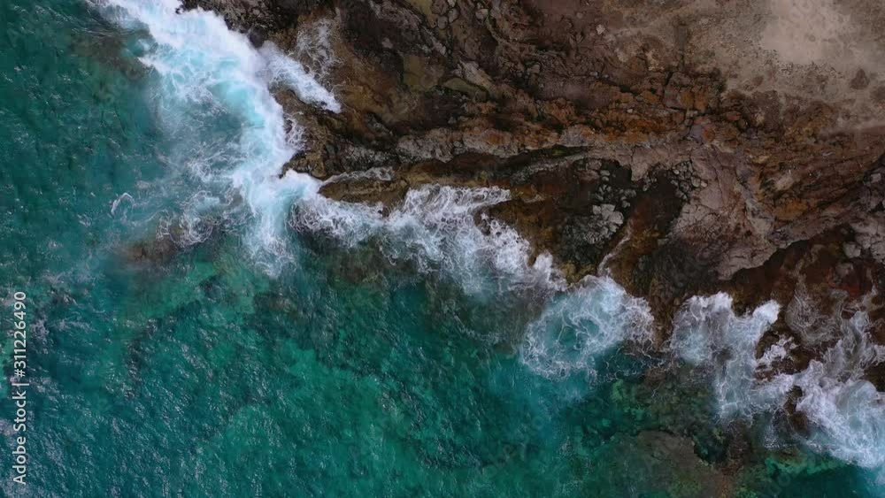 Top view of a deserted coast. Rocky shore of the island of Tenerife. Aerial drone footage of ocean waves reaching shore Top view of a deserted coast. Rocky shore of the island of Tenerife. Aerial drone footage of ocean waves reaching shore