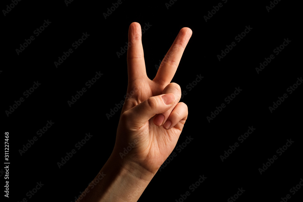 Hand Showing Sign of V Alphabet in American Sign Language (ASL), isolated on black background. Sign language Hand Showing Sign of V Alphabet in American Sign Language (ASL), isolated on black background. Sign language