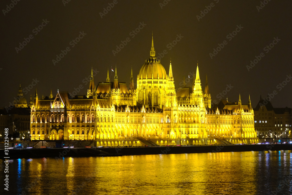 Budapest parliament house at night. Illuminated Hungarian parliament building with reflection in Danube river.