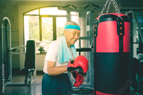 Фототапет Portrait of old Asian man boxing enthusiastically