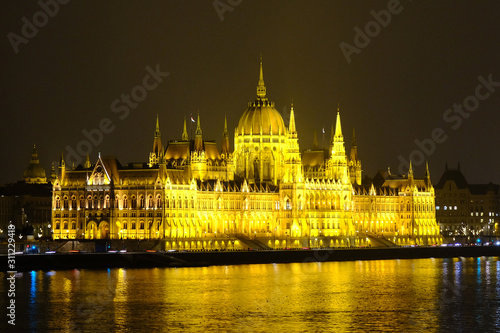 Budapest parliament house at night. Illuminated Hungarian parliament building with reflection in Danube river.
