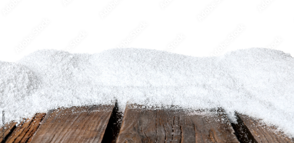 Heap of snow on wooden surface against white background