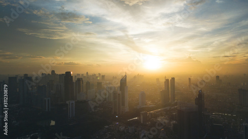 Yellow sunrise or sunset in cityscape of Jakarta