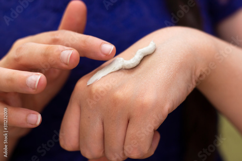 Woman Hands Applying Cream