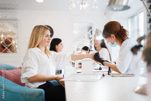 Group of girlfriends, manicure in beauty salon photo