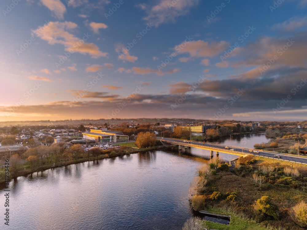 Sunset over Galway city and river Corrib, Blue cloudy sky, aerial view. Bridge over water. Ireland.