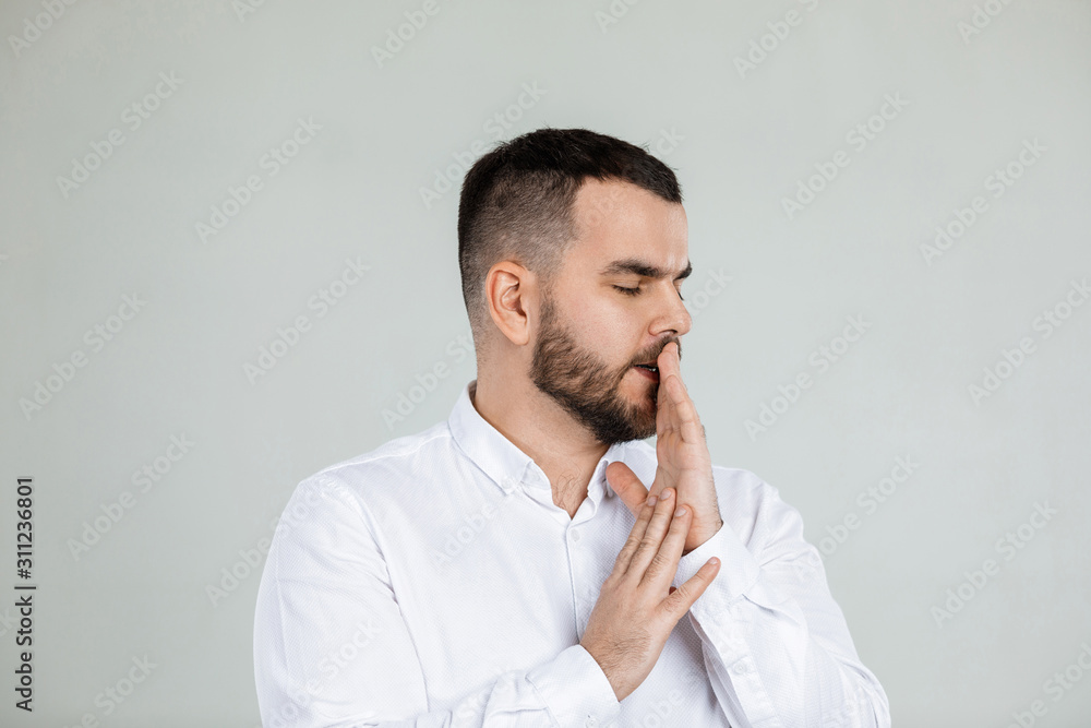 doubtful bearded man thinking about something on gray background. doubtful bearded man thinking about something on gray background.