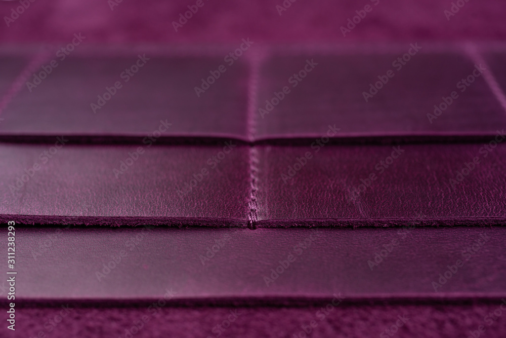 Purple handmade leather wallet details closeup Purple handmade leather wallet details closeup