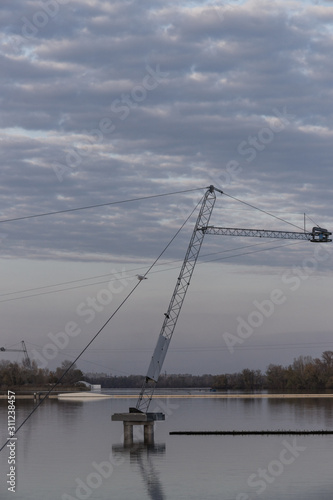 Seagull sitting on a rope above the river
