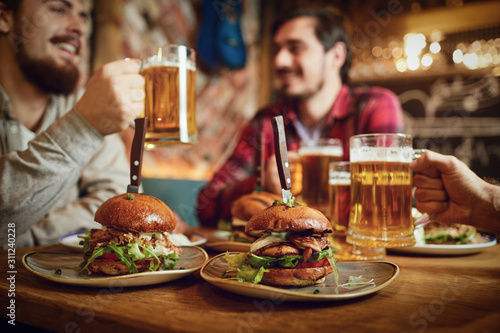 Foto Burger with beer on the table in a bar pub.
