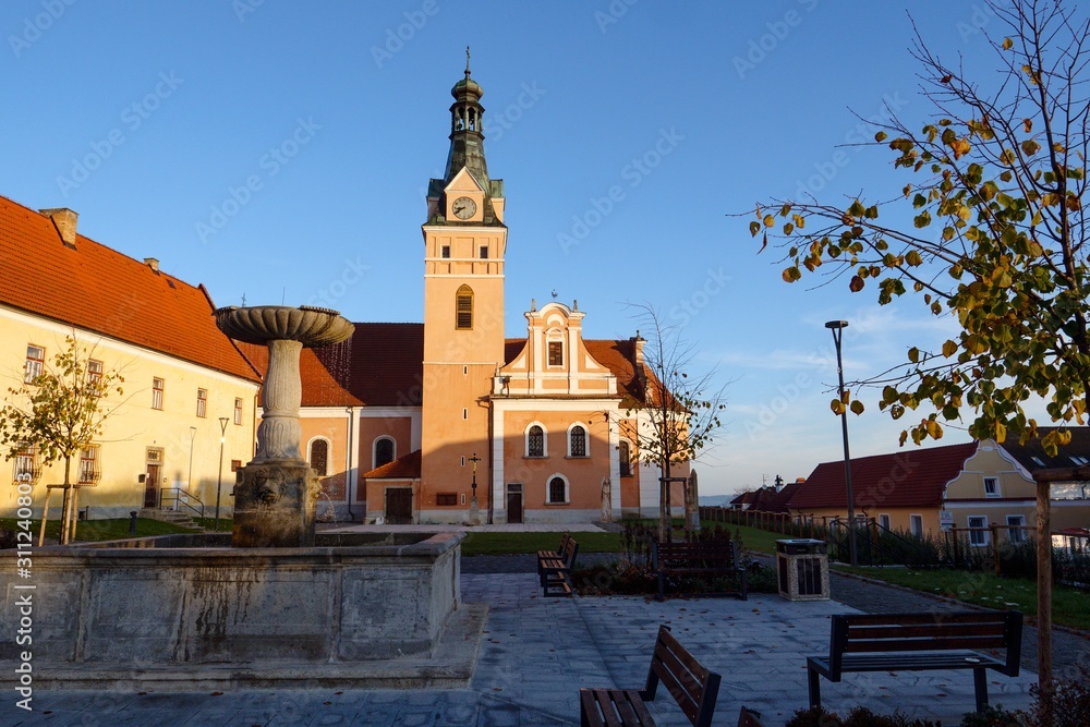 Village square with church at sunrise.