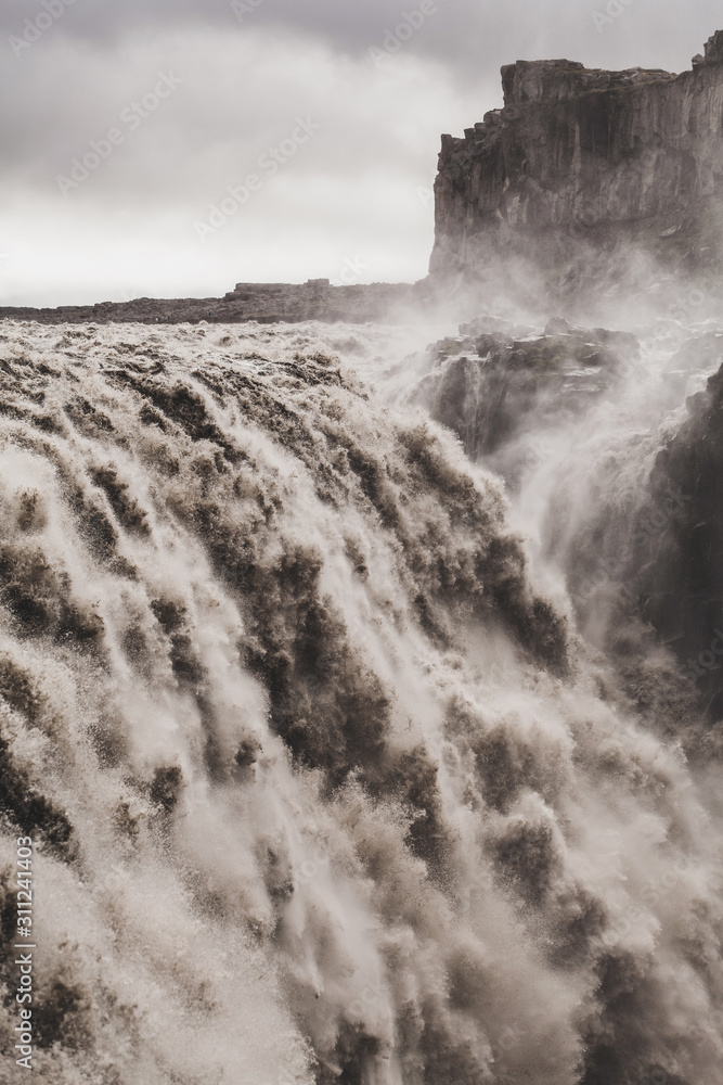 Dramatic view of famous Iceland waterfall Dettifoss. Breathtaking landscape, stream of water, most powerful waterfall in Europe.