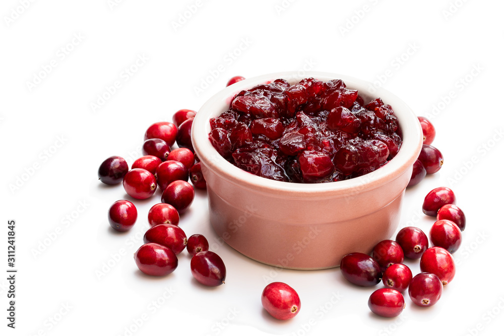 Fresh cranberries in ceramic pot isolated on white Fresh cranberries in ceramic pot isolated on white